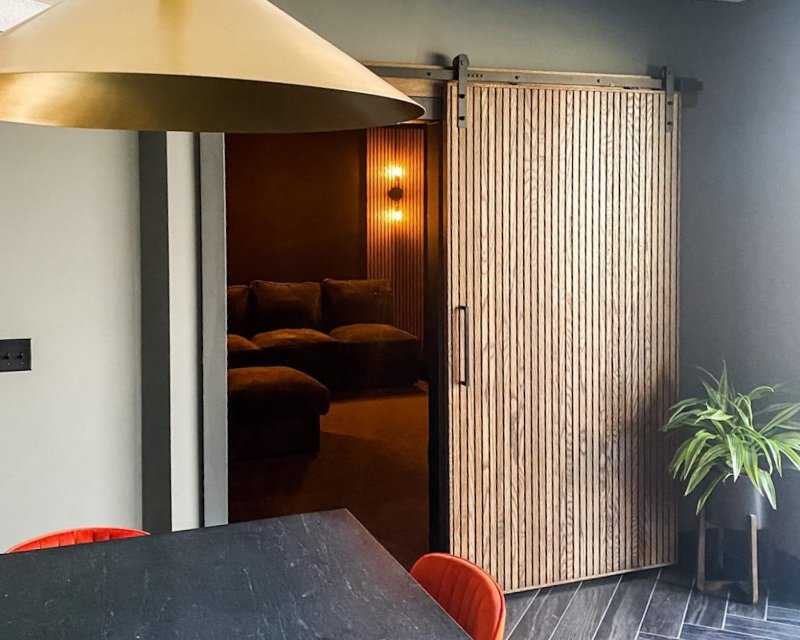 modern slat sliding door made of white oak wood in a modern home